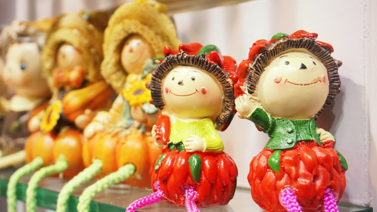 Close-up of colorful decorative dolls with cheerful expressions, perfect for home décor.